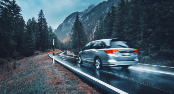 blurred car in motion on the road in autumn forest 487SRPW 1 scaled